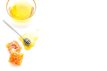 Honey background. Honey dipper and honeycomb on white background top view copy space