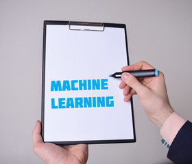 A businessman shows an inscription:MACHINE LEARNING