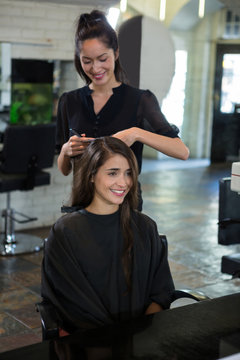 Female getting her hair trimmed at a salon