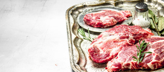 Fresh raw beef meat with spices and herbs.