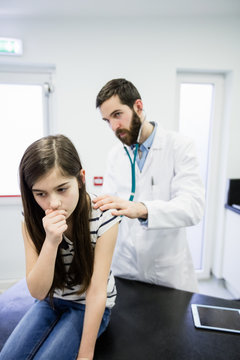 Doctor examining a sick girl