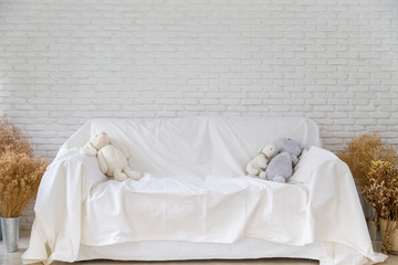 White sofa with white brick wall background
