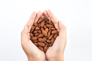 Almonds on hand isolated on white background