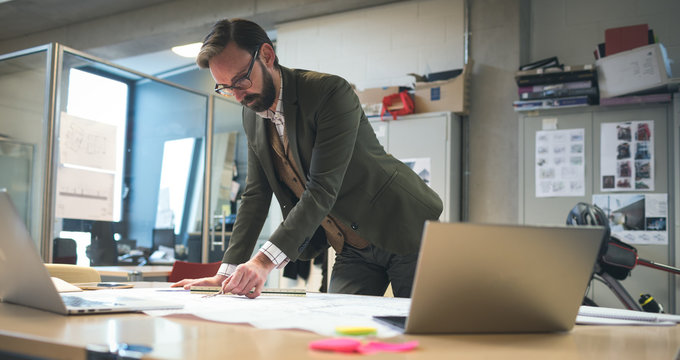 Business executive working on blueprint
