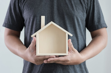 hands holding house .homeless housing shelter  architecture  building  construction, real estate and property