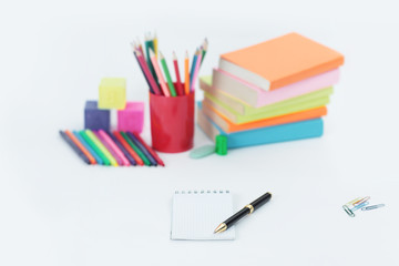 pen and Notepad on blurred background of school supplies .photo with copy space