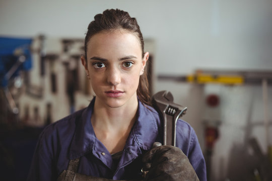 Female welder holding wrench tool