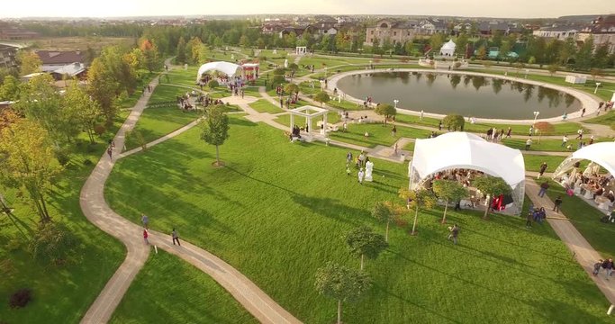 Aerial view over beautiful cottages. Small green village from above, top view of Houses in a neighborhood area. Countryside, real estate and private property concept.