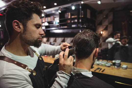 Man getting his hair trimmed with trimmer