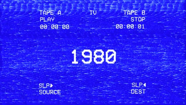 An old damaged VHS tape tracking a bad signal coming from a double deck, with the text 1980 (year).
