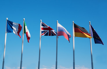 international flags against blue sky