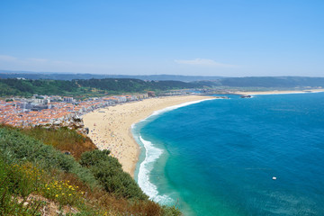 Fototapeta na wymiar Bird's-eye view on Nazare beach riviera on the coast of Atlantic ocean. Nazare. Portugal