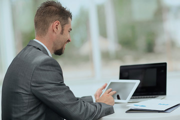 closeup.successful businessman working with tablet computer