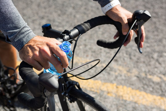 Cropped hand of athlete cycling