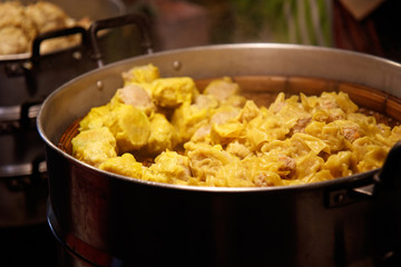 Chiang Mai, Thailand - April 8, 2018 : Street food (Pork Dumpling with steam) at the Sunday Night Market Walking Street on April 8, 2018 in Chiang Mai, Thailand. Selective focus.