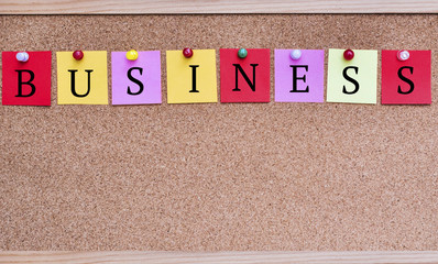 Obraz premium Business Text from Paper Notes Pinned to a Cork Board