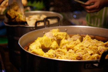 Chiang Mai, Thailand - April 8, 2018 : Street food (Pork Dumpling with steam) at the Sunday Night Market Walking Street on April 8, 2018 in Chiang Mai, Thailand. Selective focus.