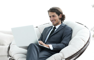 close-up of smiling businesswoman working with laptop in living room.