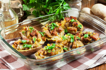Baked potatoes in jacket stuffed with bacon, mushrooms and cheese. Dish served in baking dish..Baked potatoes stuffed with bacon, mushrooms and cheese