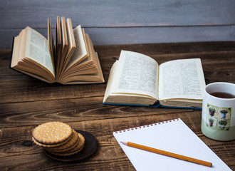 cookies and tea open book pencil notebook