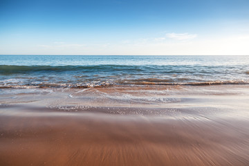 ocean coast, sand beach and foamy waves, beautiful natural vacation background and texture