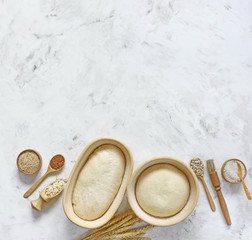 Dough for bread on leaven, yeast, in baskets for proofing dough.