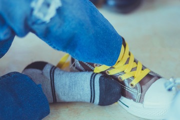 Kid is tying shoes laces before stage show in school