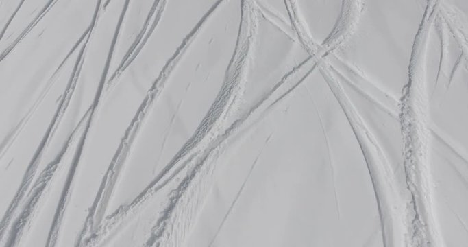 Traces of skis in the powder snow mountain