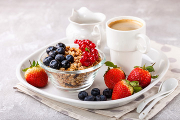 Breakfast - muesli, berries and coffee. Selective focus. Copy space