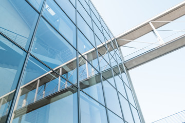 Fototapeta na wymiar Glass facade and reflection, modern architecture building exterior and blue sky