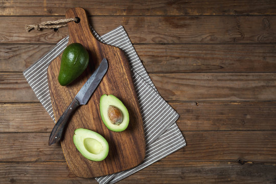 Halves of fresh avocado on a cutting board. 31996423 Stock Photo at Vecteezy