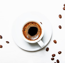 White cup of black coffee espresso with foam, white background, top view