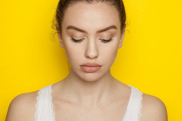 Beautiful young woman posing on yellow background © vladimirfloyd