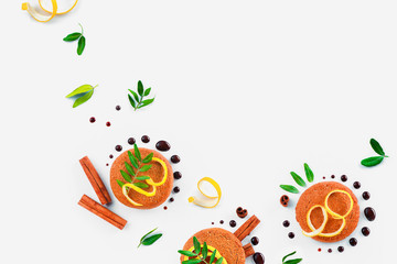Oatmeal cookies decorated with chocolate, cinnamon, lemon zest and green leaves on a white background. Food styling flat lay with copy space.