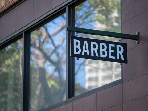 Modern Barber Sign Hanging Outside The Shop