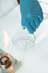 Microbiology. Hands of a microbiologist pouring agar into a petri dish