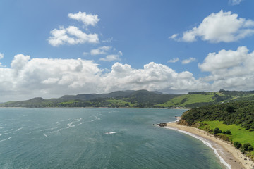 aerial view of ocean coastline on sunny summer day, Omapere, New Zealand