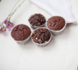 Tasty chocolate muffins on white kitchen table. 