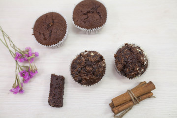 Tasty chocolate muffins on white kitchen table. 