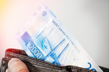 Man gets money from the wallet. Set of new russian banknotes on white background. 2000 rubles....