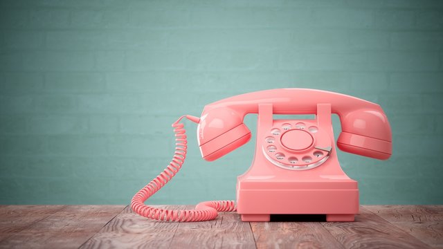 3D Rendering Pink Vintage Phone Isolated On Wood Table