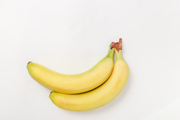 two yellow fresh big bananas on white background