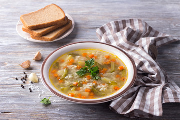 Vegan soup with pickled cucumbers and pearl barley, rassolnik. traditional homemade Russian...