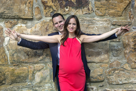 Pregnant couple spreaded arms