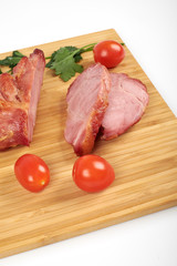 Cooked sliced pork barbecue steak on wooden cutting board on the white background