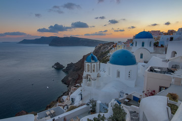 The view of epic village of Oia and the famous blue and white churches at Santorini