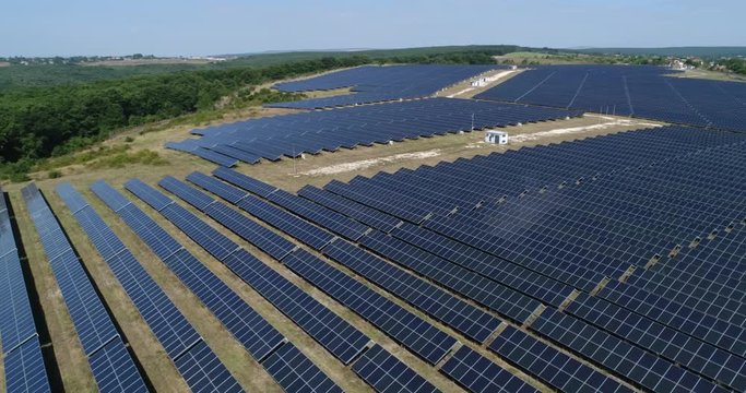 4K Aerial footage of photostatic solar farm. Solar farm power station from above. Ecological renewable energy.