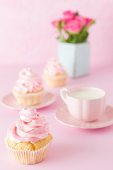 Pink pastel vertical banner with decorated cupcakes, cup of coffe with milk and bouquet of pink roses.