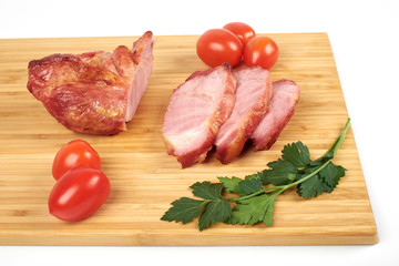 Cooked sliced pork barbecue steak on wooden cutting board.