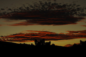October, Spain, Albarracin, beautifully colored clouds and dark tree silhouets at sunset, 